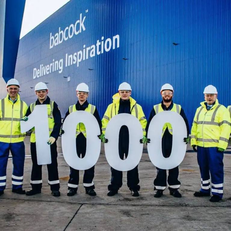 Babcock staff members holding up 1000 in their hands signifying 1000 Babcock jobs