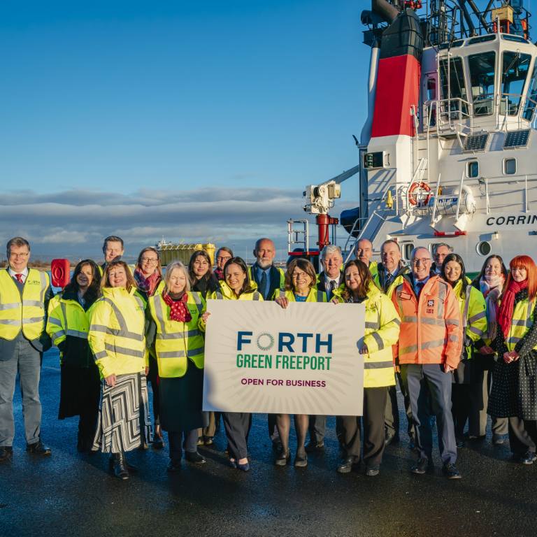 FGF staff members holding up a sign that reads open for business