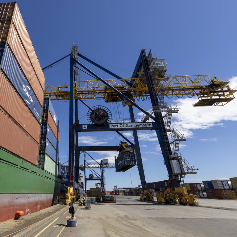 A view berthside of a container vessel being offloaded via crane at Grangemouth Port