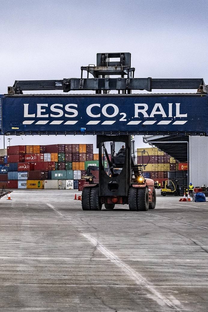 A container forklift handling a container at the Grangemouth Rail Terminal