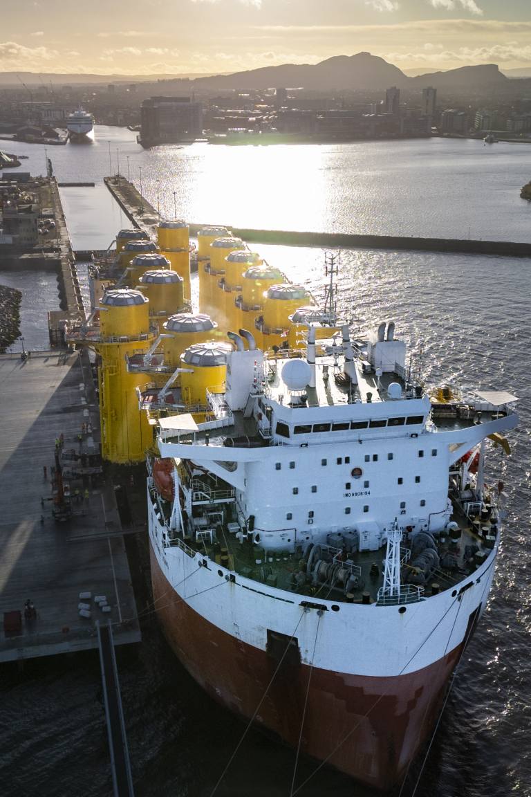 A vessel unloading windfarm pin piles at the leith port