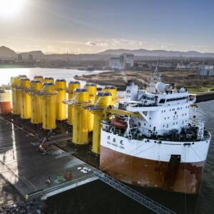A vessel unloading windfarm pin piles at the leith port